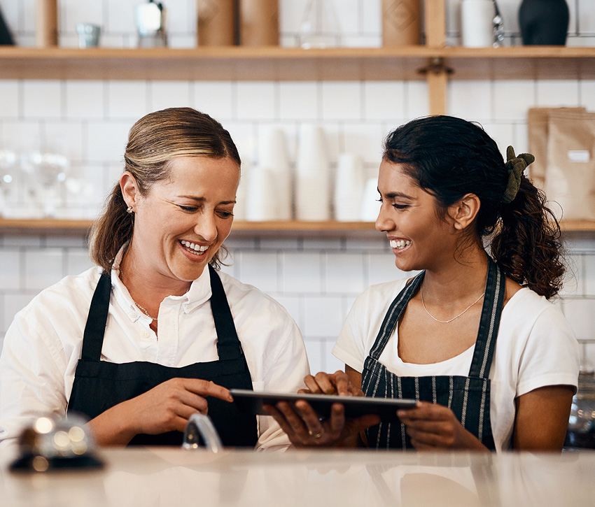 Two women using Clover product in restaurant