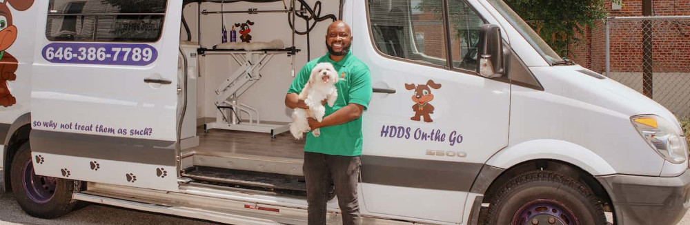 Brian Taylor in front of his doggie day spa van