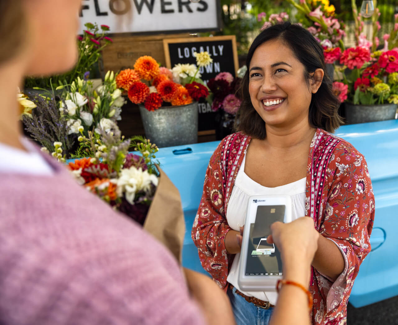 Girl in flower shop using Clover Flex